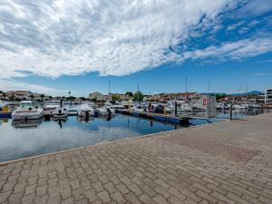 a marina with boats parked in the water at Holiday Home Le Hameau des Capellans by Interhome in Saint-Cyprien-Plage