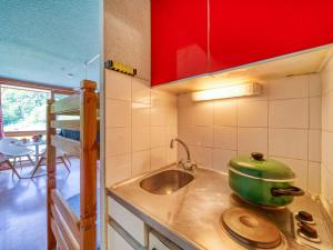 a kitchen with a sink and a green pot on the counter at Studio Soyouz Vanguard-19 by Interhome in Le Corbier