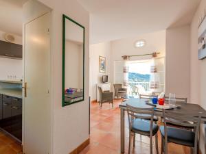 a kitchen and dining room with a table and chairs at Apartment Le Petit Village-2 by Interhome in La Garonnette-Plage