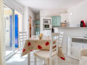 a kitchen and dining room with a table and chairs at Holiday Home Les Palombes-8 by Interhome in Lacanau-Océan