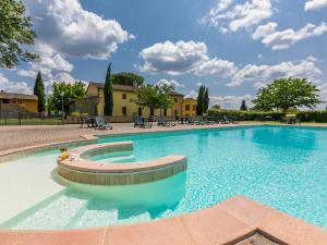 a large swimming pool with blue water at Apartment Montereggi-4 by Interhome in Limite