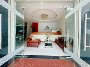 a living room with a couch and a table at White Horse Dalat Hotel in Da Lat