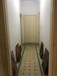 an empty hallway with paintings on the walls of a room at Spacious downtown Nile apartment in Cairo