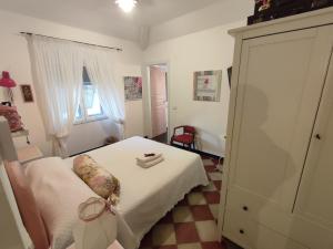 a small bedroom with a bed and a window at La BRIGNA B&B Il bosco sul mare in Genoa