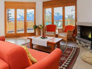 un soggiorno con mobili arancioni e camino di Apartment Domaine des Reines D1A by Interhome a Nendaz