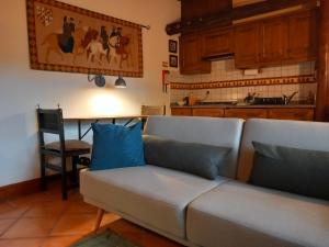 a living room with a couch and a kitchen at Casa da Vinha in Castelo Novo