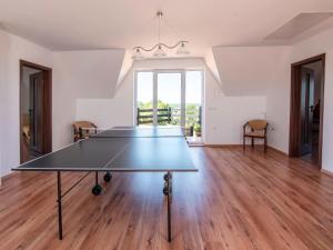 a ping pong table in the middle of a room at Holiday Home Anna by Interhome in Gardna Wielka