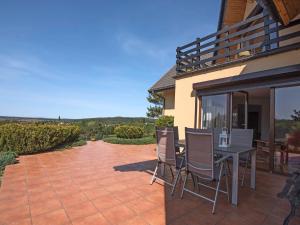 a patio with a table and chairs on a patio at Holiday Home Anna by Interhome in Gardna Wielka