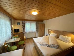 a bedroom with a large bed in a wooden ceiling at Apartment Maria by Interhome in Kappl +19 photos