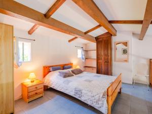 a bedroom with a bed in a room with wooden ceilings at Apartment Les Hauts des Issambres-1 by Interhome in La Garonnette-Plage
