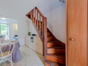 a wooden staircase in a kitchen with a table at Holiday Home Le Lagon by Interhome in Saint-Cyprien-Plage