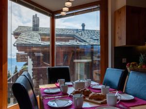 a table with a view of a building from a window at Apartment Les Cimes Blanches B 401 by Interhome in Nendaz +41 photos