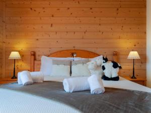 two stuffed animals sitting on top of a bed at Apartment Les Cimes Blanches B 401 by Interhome in Nendaz