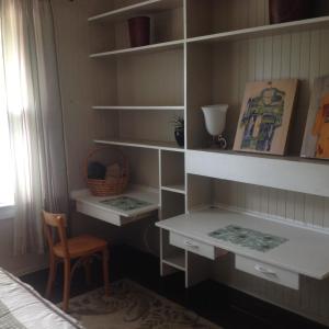 a room with shelves and a chair and a desk at Hakuna Matata Maui Hostel in Lahaina
