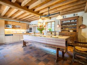 a large kitchen with a large wooden counter top at Holiday Home Manoir Kerprigent by Interhome in Cité