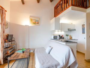 a small bedroom with a bed and a kitchen at Apartment Les Hauts des Issambres-12 by Interhome in Les Issambres