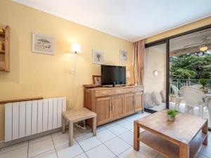 a living room with a television and a table at Apartment Villa Francia-5 by Interhome in Cannes