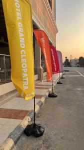 uma fila de bandeiras em frente a um edifício em فندق جراند كليوباترا الساحل الشمالى المنتزه ك80 em El Alamein