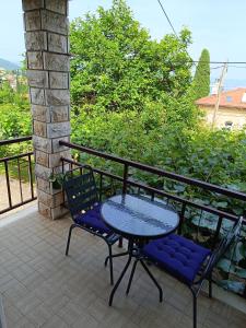 a patio with a table and chairs on a balcony at Rooms Sanja, Lovran - Opatija in Lovran