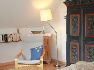 a room with a lamp and a chair and a table at Apartment Schwalbennest by Interhome in Bad Kleinkirchheim