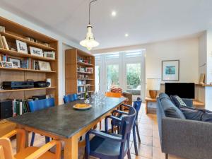 a dining room and living room with a table and chairs at Holiday Home Maison Bleue by Interhome in Saint-Jean-de-Luz