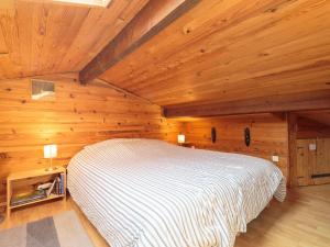 ロワイヤンにあるStudio Rampe du vengeur by Interhomeの木製の部屋にベッド1台が備わるベッドルーム1室があります。