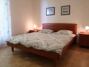 蒙特勒的住宿－Apartment Montreux - Panorama by Interhome，一间卧室配有一张带2个床头柜和2盏灯的床。