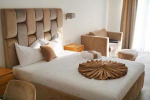 a bedroom with a large bed with a large headboard at Hotel Credo in Kotor