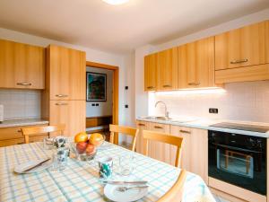 a kitchen with a table with a bowl of fruit on it at Apartment Trottner by Interhome in Mazzin