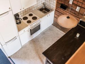 a kitchen with white cabinets and a sink at Holiday Home Skärvudde Torpet by Interhome in Kalvsvik +15 photos