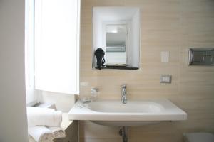 a bathroom with a sink and a mirror and towels at Palazzo della Poesia Casa Vacanze in Salerno +52 photos