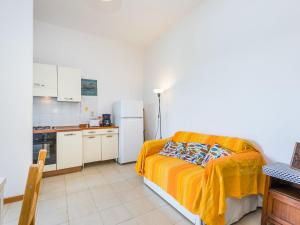 a small kitchen with a couch in a room at Holiday Home I Lecci by Interhome in Castiglioncello