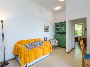 a bedroom with a bed and a green cabinet at Holiday Home I Lecci by Interhome in Castiglioncello