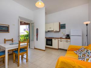 a kitchen and living room with a table and a couch at Holiday Home I Lecci by Interhome in Castiglioncello +30 photos