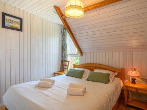 a bedroom with a large white bed with two pillows at Holiday Home Maison de la Plage by Interhome in Carnac-Plage