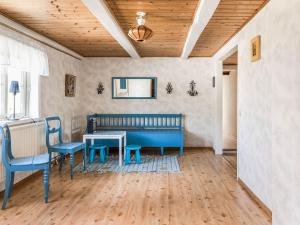 a room with a blue bench and a table and chairs at Holiday Home Gåragöl by Interhome in Olofström +20 photos