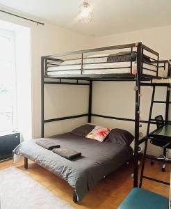 a bedroom with two bunk beds in a room at Maison de ville calme in La Roche-sur-Yon