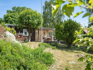 a small house in the middle of a yard at Holiday Home Djursvik - SND029 by Interhome in Söderåkra