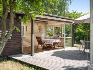a patio with a table and chairs on a deck at Holiday Home Djursvik - SND029 by Interhome in Söderåkra
