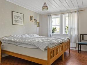 a bedroom with a bed and a window at Holiday Home Matvik by Interhome in Trensum