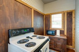 a kitchen with a stove and a microwave at New Braunfels Vacation Rental on Lake Dunlap! in New Braunfels