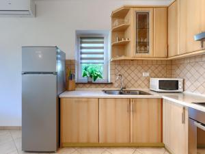 a kitchen with a refrigerator and a sink at Apartment Mir by Interhome in Vošteni
