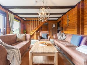 a living room with couches and a coffee table at Apartment Am Hohen Bogen-18 by Interhome in Arrach