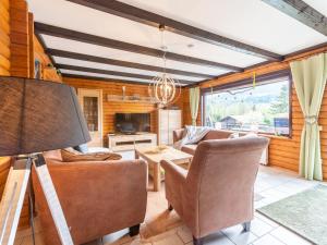 a living room with a couch and chairs and a table at Apartment Am Hohen Bogen-18 by Interhome in Arrach