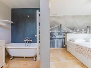 a bathroom with a bath tub next to a bed at Holiday Home L'Oliveraie by Interhome in Saint-Didier