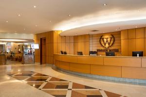 a lobby of a hotel with a hotel sign on the wall at Windsor Plaza Copacabana in Rio de Janeiro