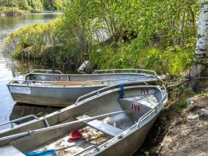 two boats sitting on the side of a river at Holiday Home Erikstorp Trean - B in Olofström