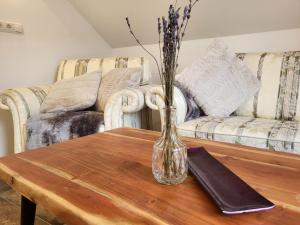 a glass vase on a wooden table in a living room at Apartment Home Fuchsbau by Interhome in See