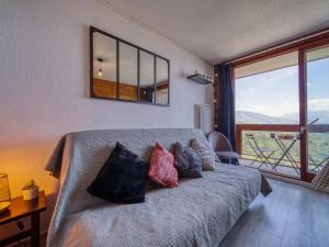 a bedroom with a bed with pillows on it at Apartment Pegase Phenix-72 by Interhome in Le Corbier +30 photos