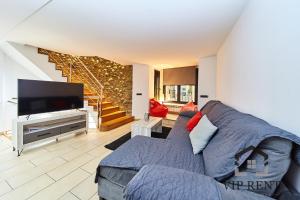 a living room with a couch and a flat screen tv at Borda Candia,jacuzzi ,Parking in Encamp